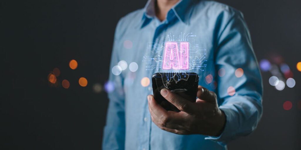 pessoa segurando o celular e saindo o holograma de ai, inteligenciar artificial da tela
